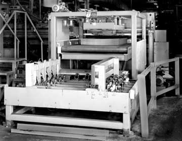 This heavy-duty feeder from Union Tool  is actually a dual station de-stacker that accepts a pair of 150-sheet stacks of steel and feeds them into a forming machine a sheet at a time using vacuum cups to lift the sheets up to pass height, and then feeding them into the former through a set of heavy pinch rollers.